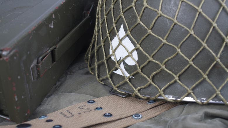 A close-up of a net with a white object inside and a wooden surface below.