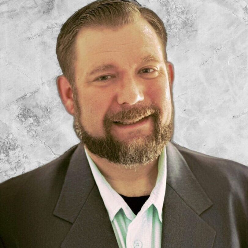 Mr. Craig A man with a beard and mustache wearing a suit.